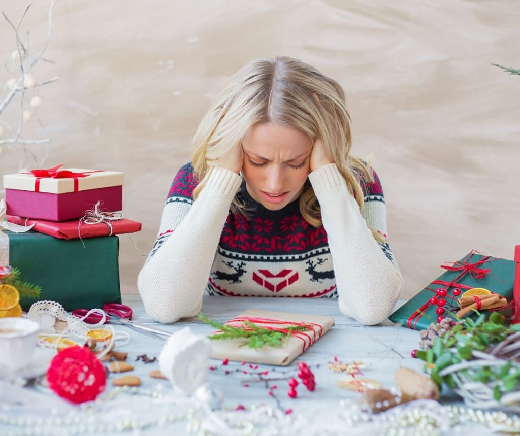 stressed woman surrounded by holiday wrapping