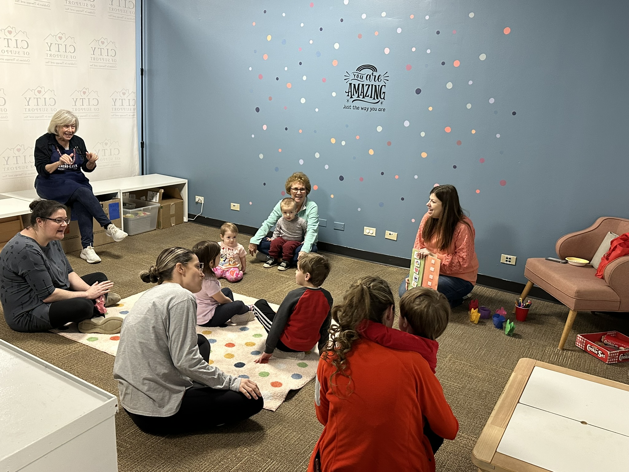 A class with children and parents at the toy shop